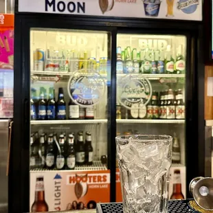 a glass of beer on a bar