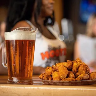 a plate of fried chicken and a glass of beer