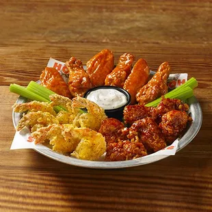 a plate of chicken wings with ranch dip