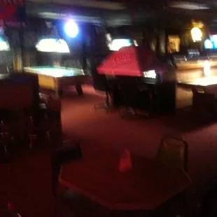 a pool table and pool tables in a dark room