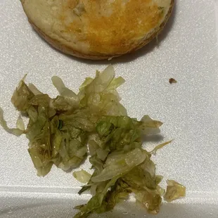 a sandwich and lettuce on a tray