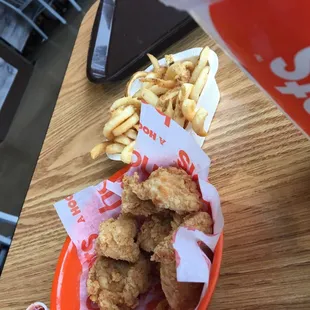 a bowl of fried chicken and french fries