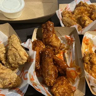 a tray of chicken wings and fries