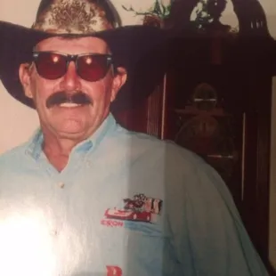 a man wearing a cowboy hat and sunglasses