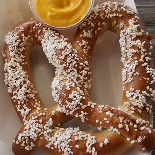 A soft pretzel with cheese. It costs $5.