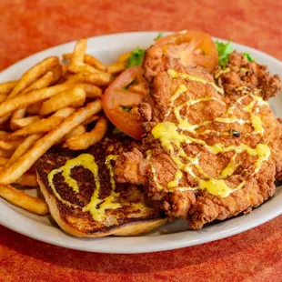 a plate of fried chicken and french fries