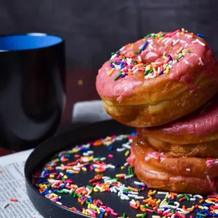 a stack of doughnuts with sprinkles