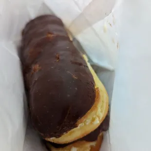 a chocolate covered donut in a wrapper