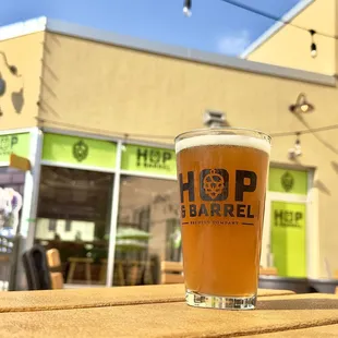 a glass of beer sitting on a table