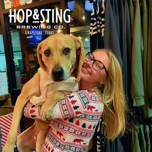 a woman holding a dog