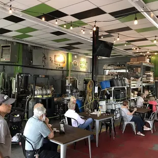 people sitting at tables in a restaurant