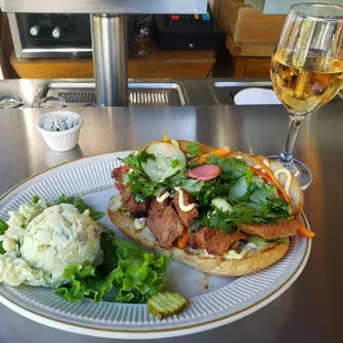 a plate of food and a glass of wine