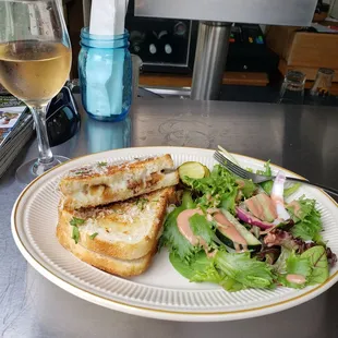 a plate of food and a glass of wine