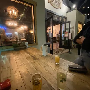 two glasses of beer on a wooden table