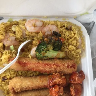 Crab sticks with shrimp fried rice topped with some sesame chicken and broccoli