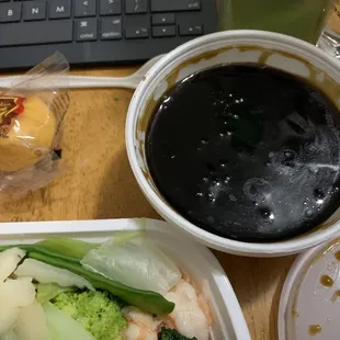 a bowl of soup and a bowl of broccoli