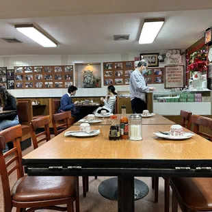 people sitting at tables in a restaurant