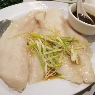 a plate of fish and vegetables