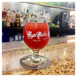 a glass of beer on a bar