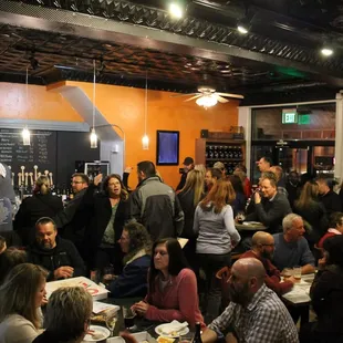 a large group of people eating and drinking
