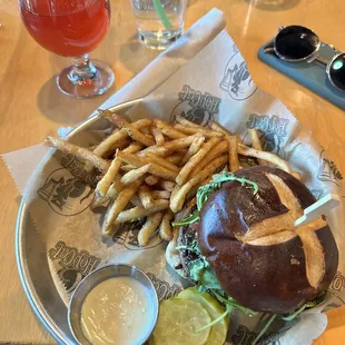 a burger with fries and a drink