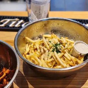 a bowl of fries and a glass of beer