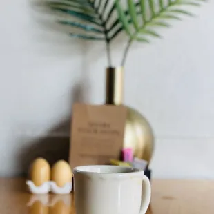 a coffee cup and saucer on a wooden table