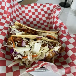 Pork taco and a hot fried chicken honey and slaw taco.