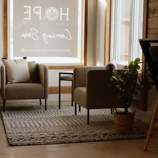 two chairs and a table in front of a window