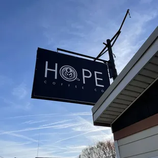 a sign hanging from the side of a building