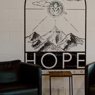 two chairs in front of a coffee shop sign
