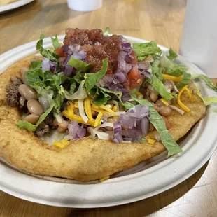 The Original, fluffy frybread, beans with meat, lettuce, tomatoes, cheese, and salsa.