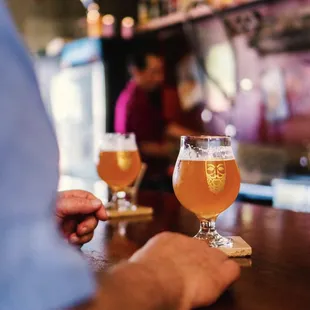 a man holding a glass of beer