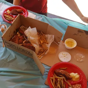 a box of food and a plate of fries