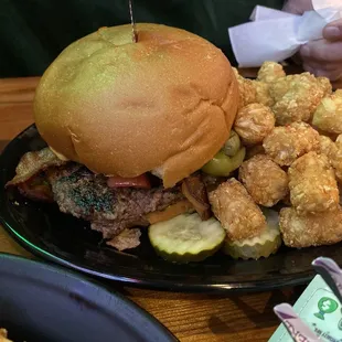 Bacon cheese burger with green olives and side of tots!