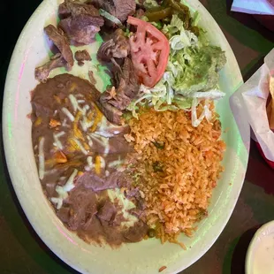 Carnitas with Rice and Beans, served with side of salad with guacamole and soft tortillas