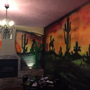 a desert scene painted on a wall