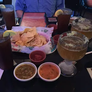 Chips with fresh tomato, habanero, and tomatillo salsas and Tecate with a lime rimmed schooner