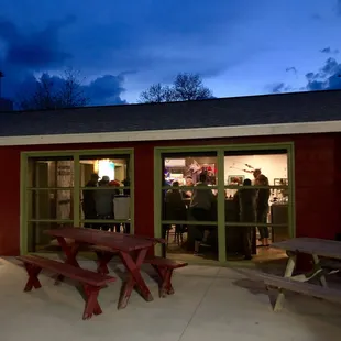 Night view of the brewpub doors open with dark blue skies above