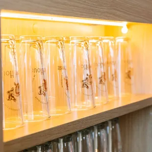 a row of glasses on a shelf