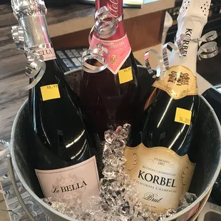 three bottles of wine in a bucket