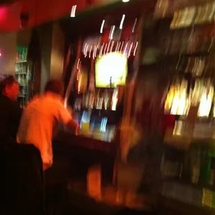 a blurry photo of people at a bar