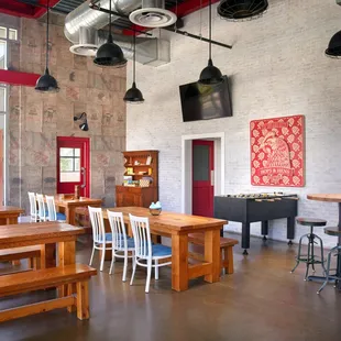 a large room with tables and stools