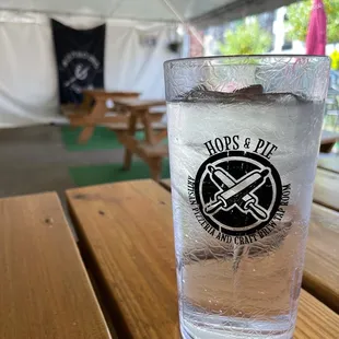 a glass of water on a picnic table