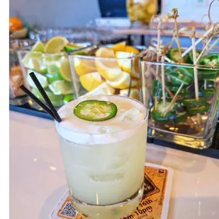 a margarita with a slice of cucumber