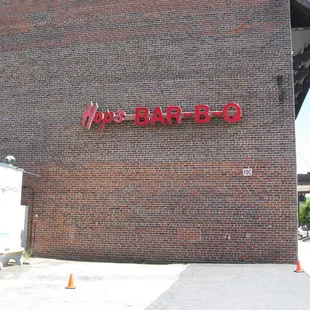 ows a brick building with a neon sign