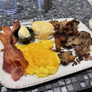 Two egg breakfast with smashed potatoes, biscuit and a side of hollandaise.
