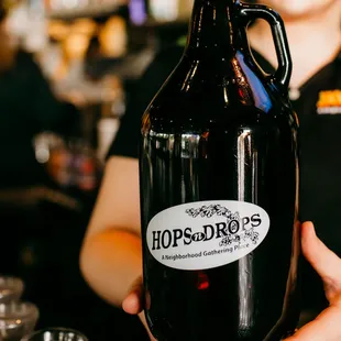 a woman holding a growler