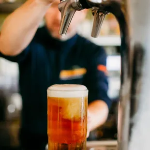 a man pouring a pint of beer