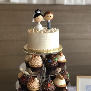 a wedding cake and cupcakes